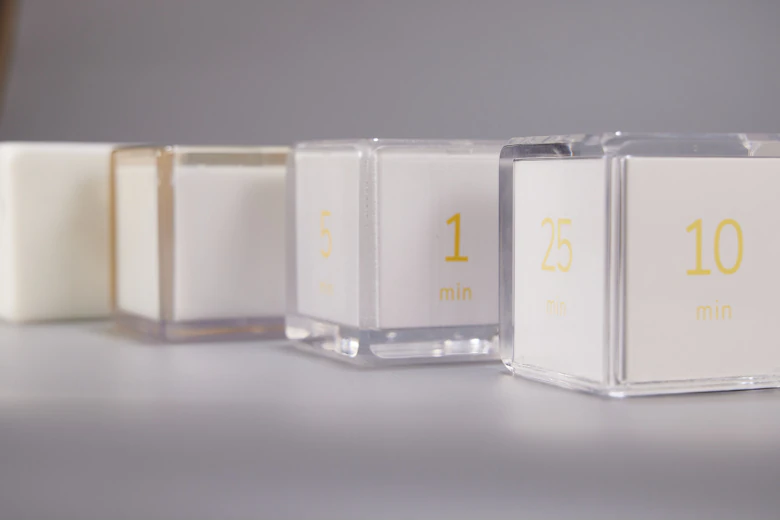 Several Settledy prototypes arranged from early model to final cube